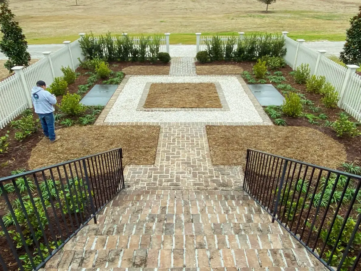 Formal stone courtyard with crisp garden borders and a Lowcountry estate setting