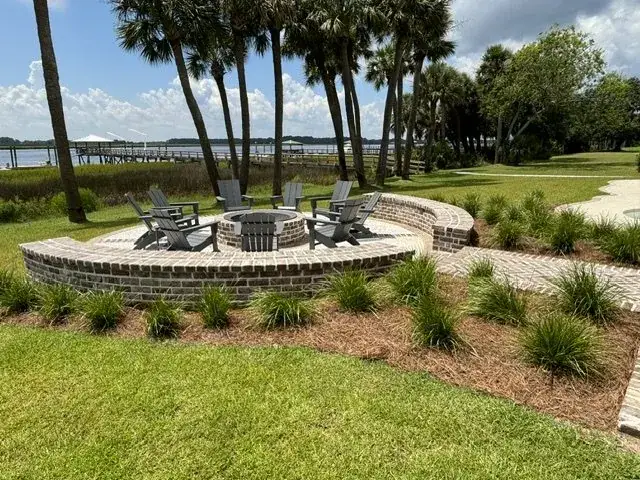 Outdoor fire pit and seating area with landscape planting