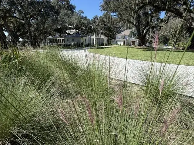 Completed fire pit project surrounded by lawn and planting