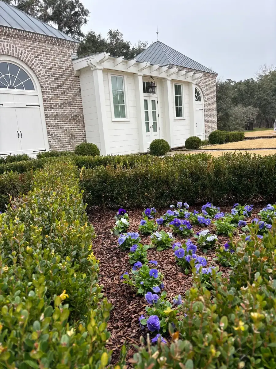 Formal flower beds and clean lawn edging at a Lowcountry estate